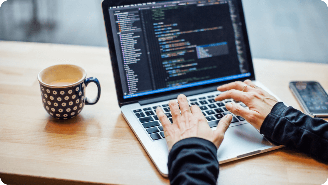 Person working in a coding program on their laptop.